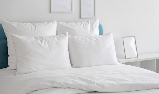 pillows and a comforter on a blue bed