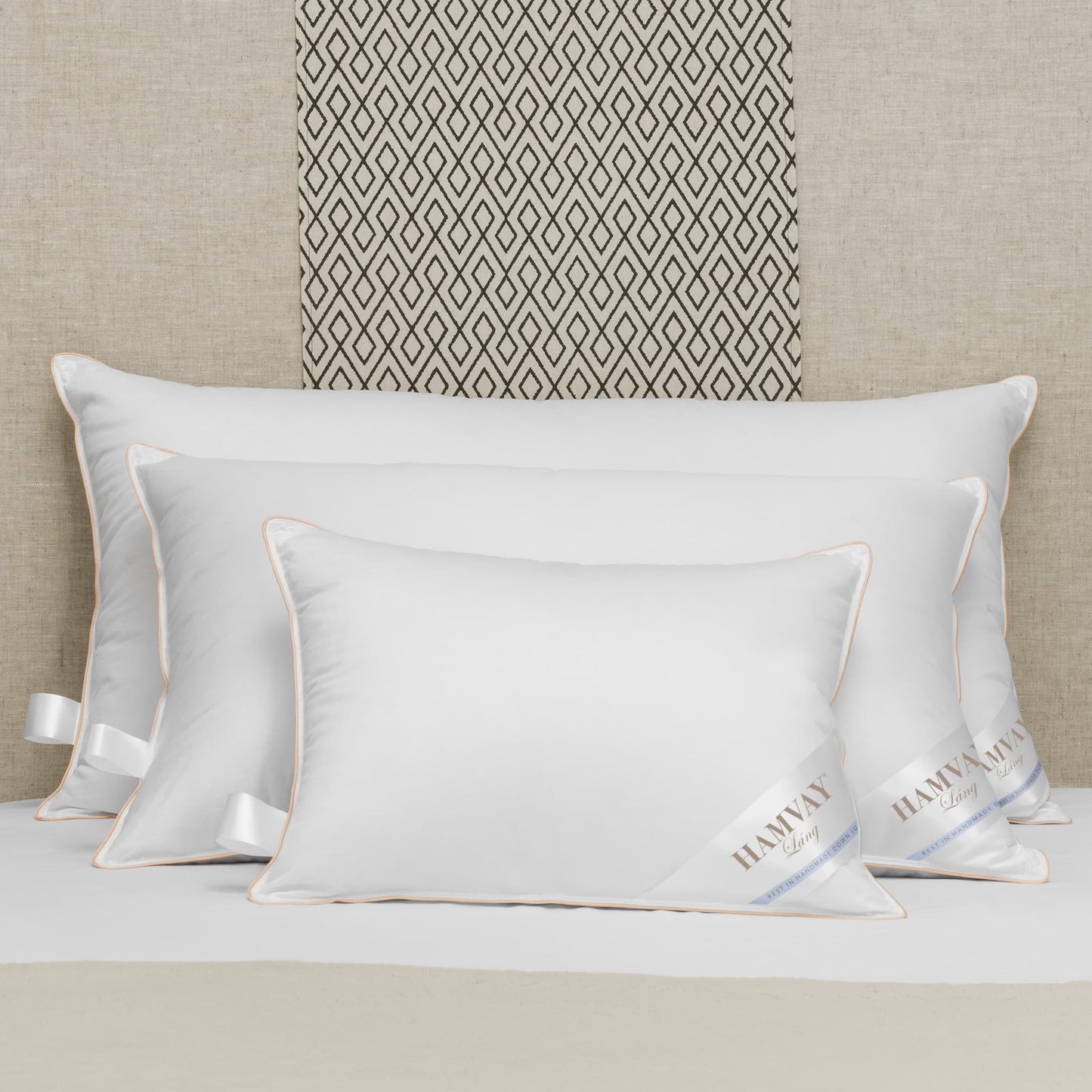 3 sizes of soft luxurious Hungarian goose down pillows on a beige bed