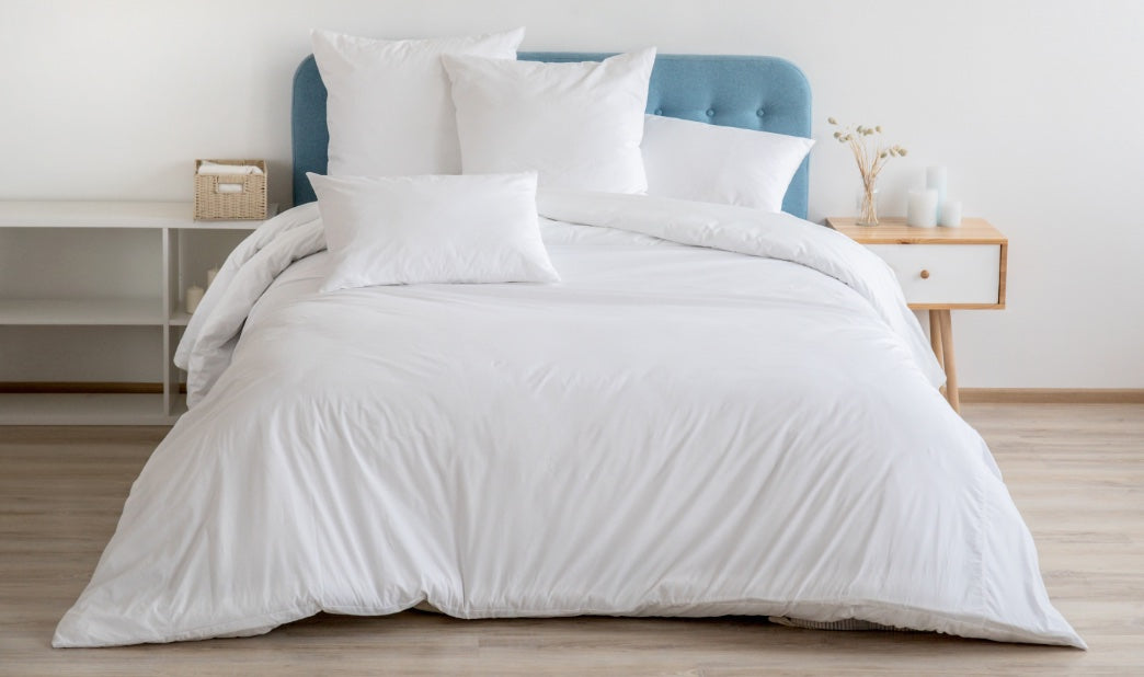 goose down pillows on a blue bed
