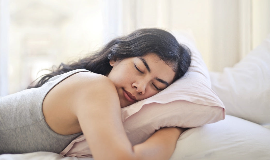 woman sleeping peacefully while hugging a pillow