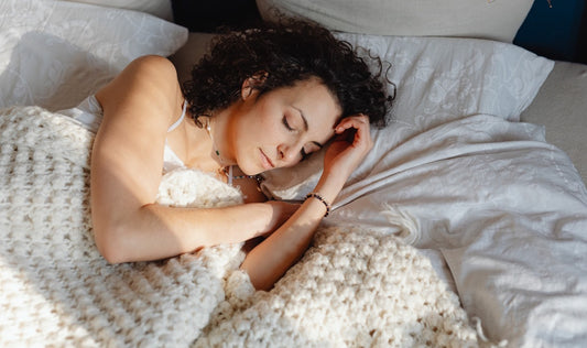 young woman sleeping peacefully with a blanket