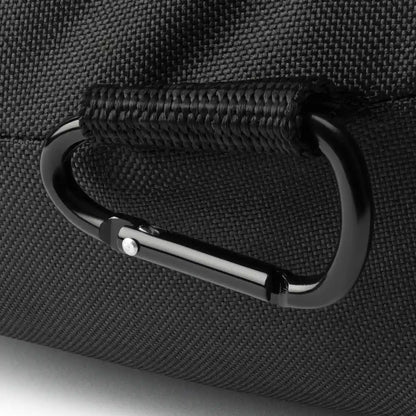 Close-up of a black carabiner attached to a textured black surface