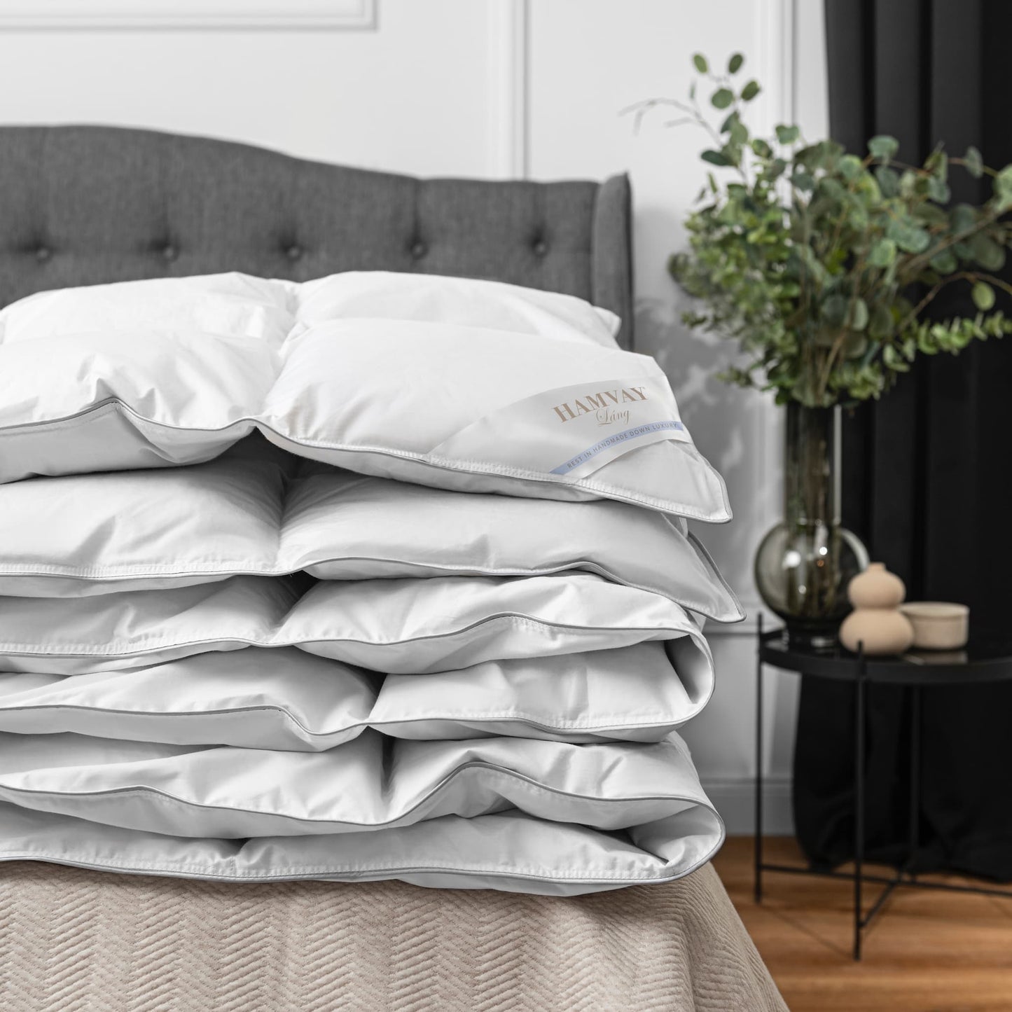Ultimate Hungarian goose down comforter folded on a grey bed