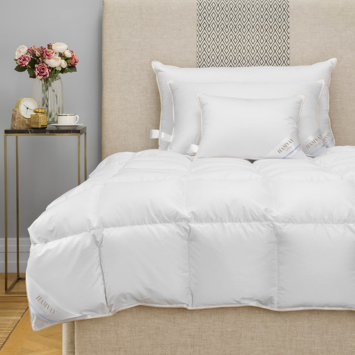 Luxurious Hungarian goose down comforter and pillows on a beige bed
