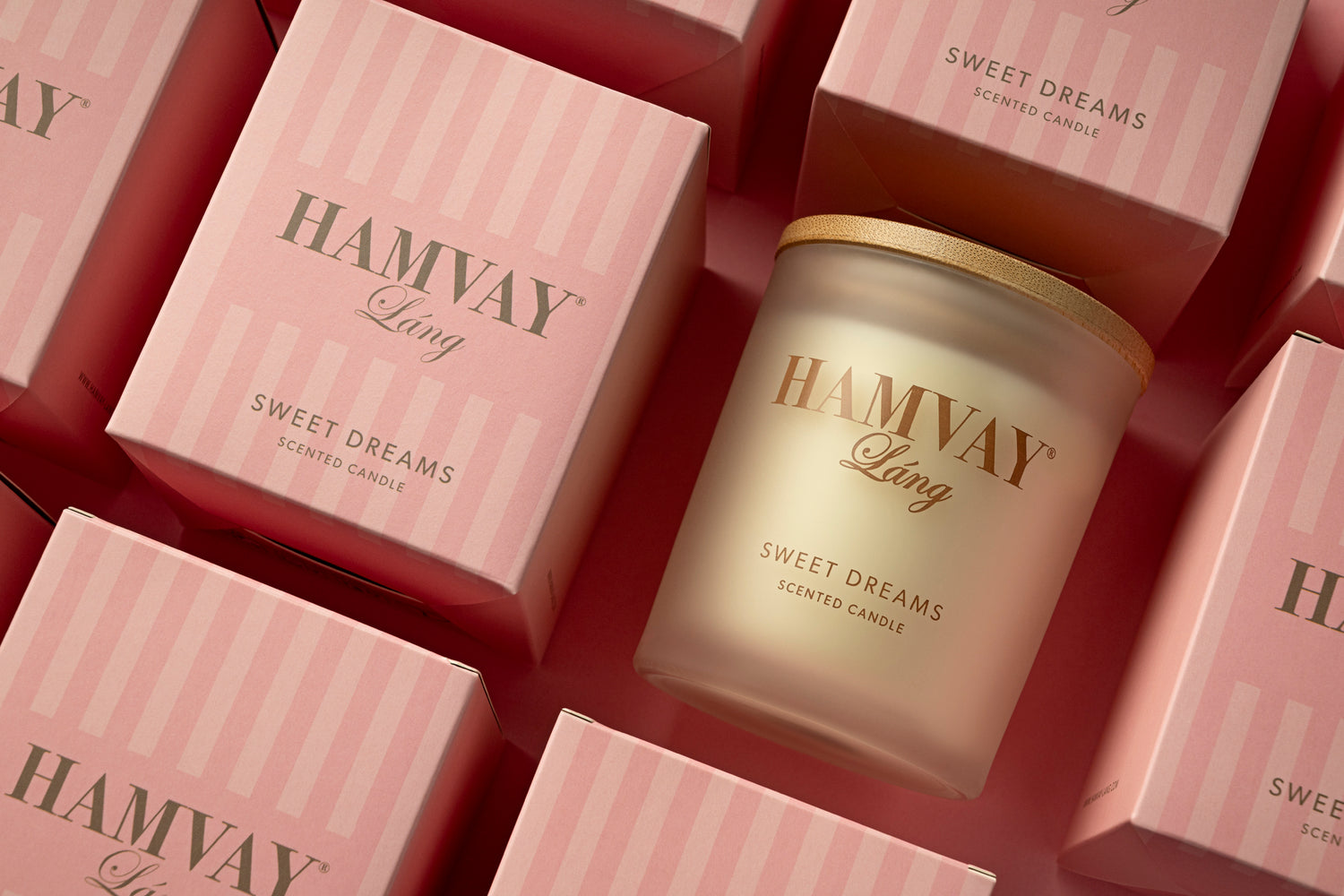 Hamvay-Láng scented candle with packaging on a pink background
