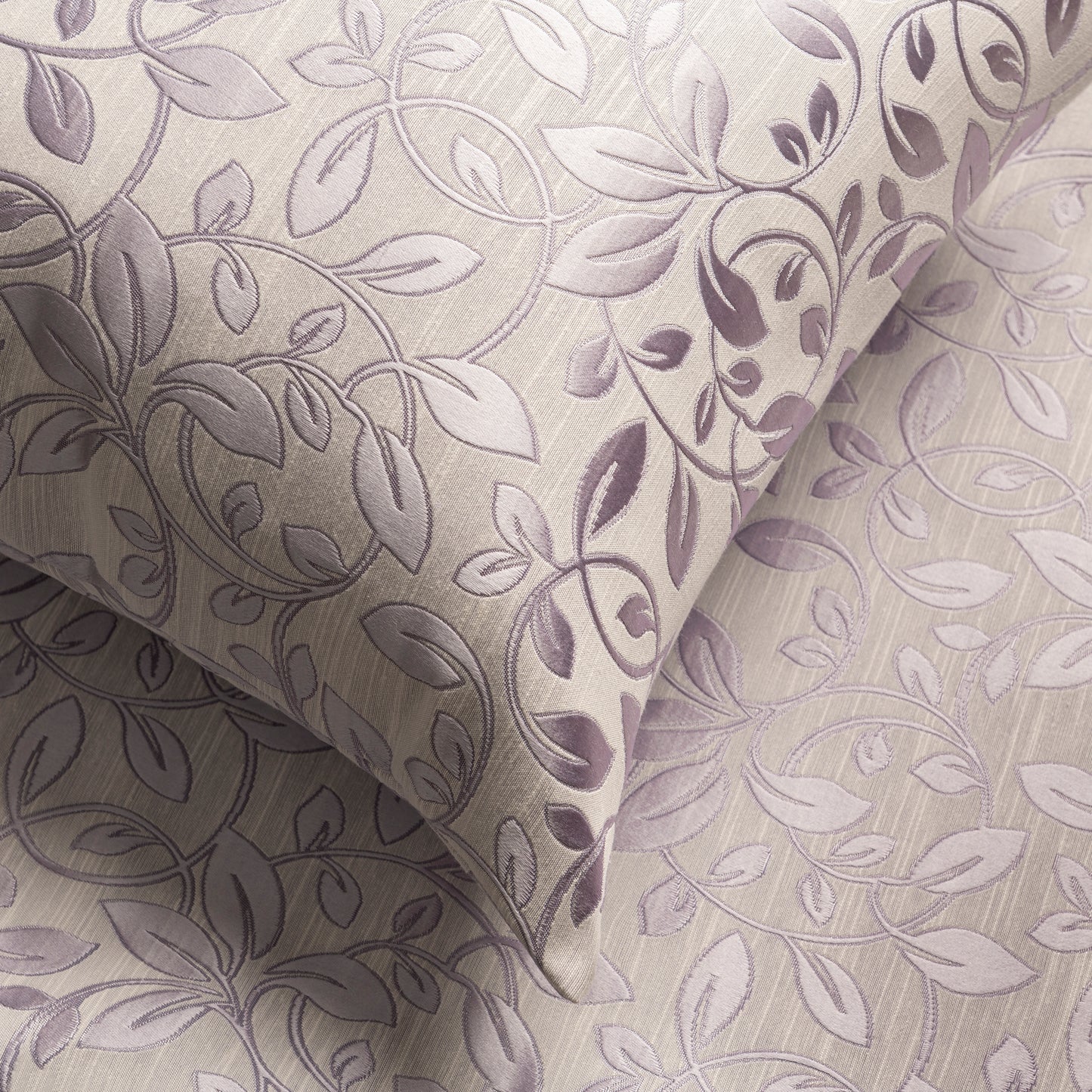 Purple floral decorative pillow captured closely