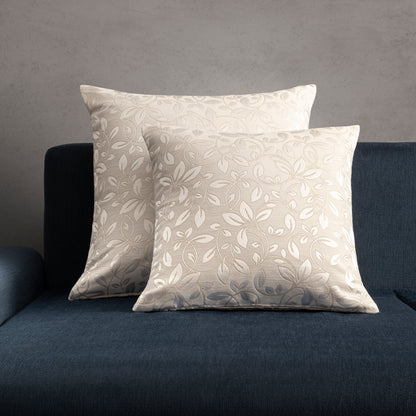 2 floral decorative pillows placed on a blue sofa
